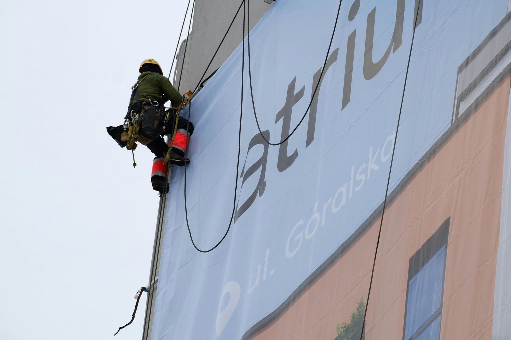 Technician inspecting an outdoor advertising installation